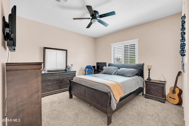 532 Gentry Way, El Paso, TX 79928 - bedroom with light carpet, a ceiling fan, and a textured ceiling
