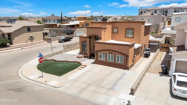 532 Gentry Way, El Paso, TX 79928 - view of front of property with a residential view, stucco siding, and concrete driveway