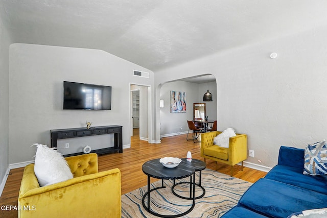 3408 Stanton St 233179, El Paso, TX 79902 - living area with vaulted ceiling, wood finished floors, baseboards, and arched walkways
