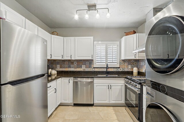 3408 Stanton St 233179, El Paso, TX 79902 - kitchen with stainless steel appliances, stacked washer / drying machine, a sink, and white cabinets