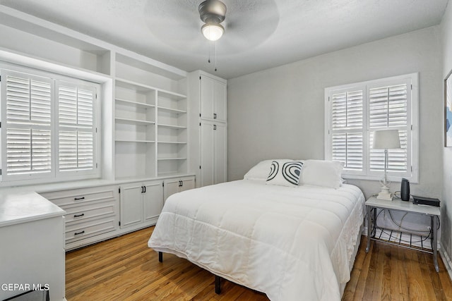 3408 Stanton St 233179, El Paso, TX 79902 - bedroom featuring wood finished floors, multiple windows, and a ceiling fan