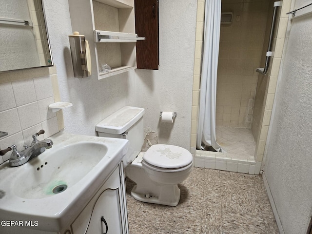 3812 Wilson Way, El Paso, TX 79903 - full bathroom featuring a textured wall, toilet, a shower stall, vanity, and tasteful backsplash