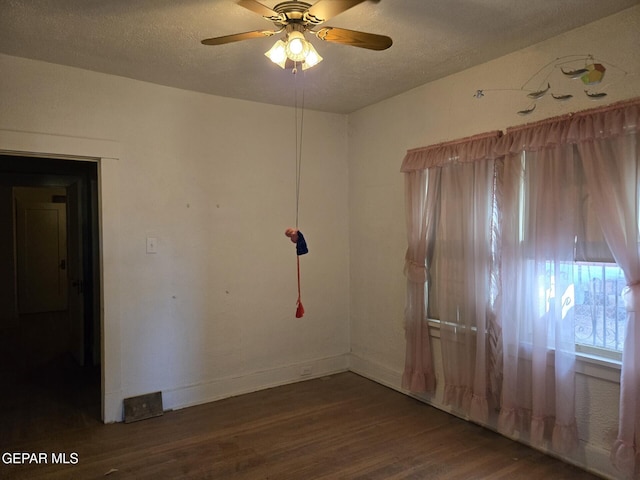 3812 Wilson Way, El Paso, TX 79903 - spare room with wood finished floors, a textured ceiling, a ceiling fan, and baseboards