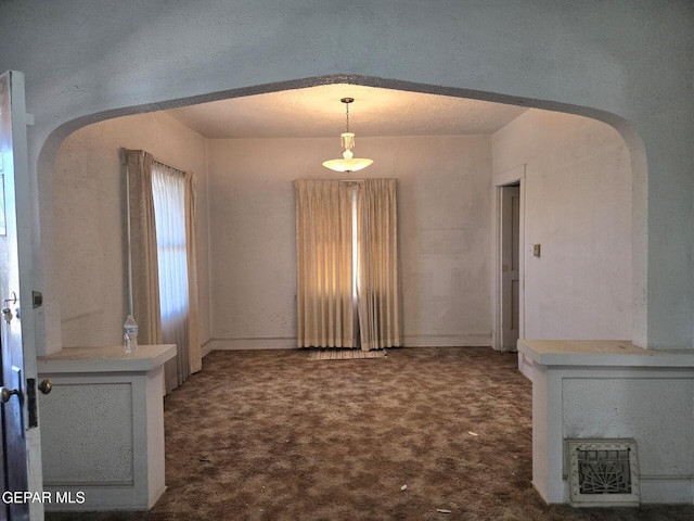 3812 Wilson Way, El Paso, TX 79903 - empty room with arched walkways and dark carpet