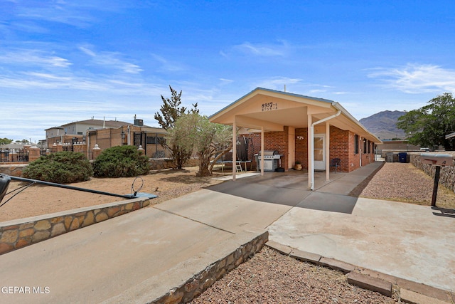 8957 Robert Dr Unit A & B, El Paso, TX 79904 - view of front of house with brick siding, a mountain view, and driveway