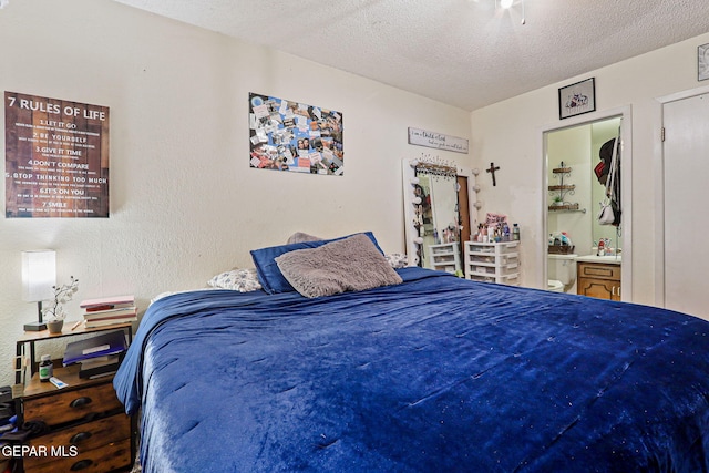 8957 Robert Dr Unit A & B, El Paso, TX 79904 - bedroom featuring a textured ceiling and connected bathroom