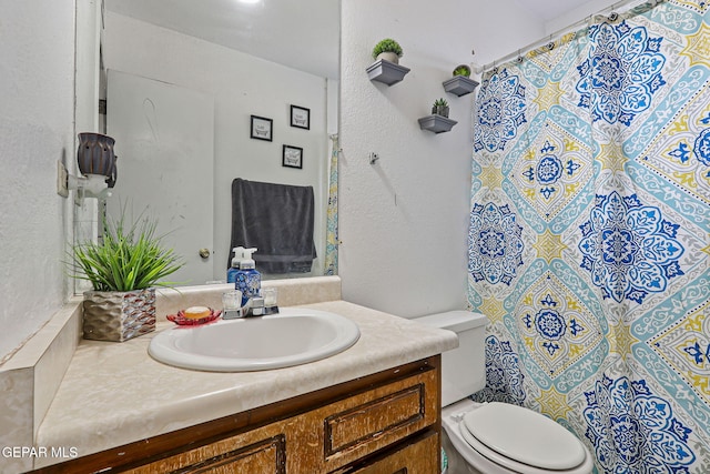 8957 Robert Dr Unit A & B, El Paso, TX 79904 - bathroom with vanity, toilet, a textured wall, and a shower with curtain