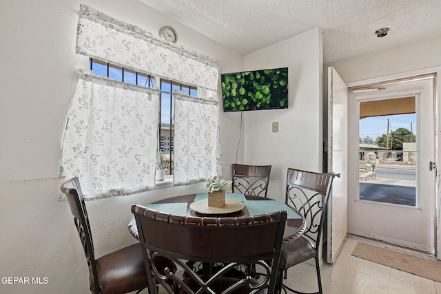 8957 Robert Dr Unit A & B, El Paso, TX 79904 - dining space featuring healthy amount of natural light and a textured ceiling