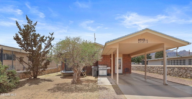 8957 Robert Dr Unit A & B, El Paso, TX 79904 - view of property's community featuring a trampoline and an attached carport