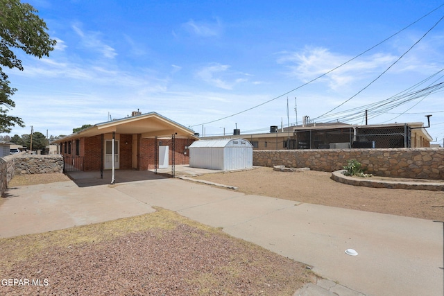 8957 Robert Dr Unit A & B, El Paso, TX 79904 - view of front facade featuring concrete driveway, a carport, and brick siding