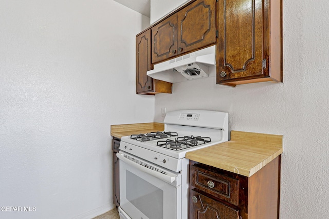 8957 Robert Dr Unit A & B, El Paso, TX 79904 - kitchen featuring white range with gas stovetop, under cabinet range hood, and light countertops