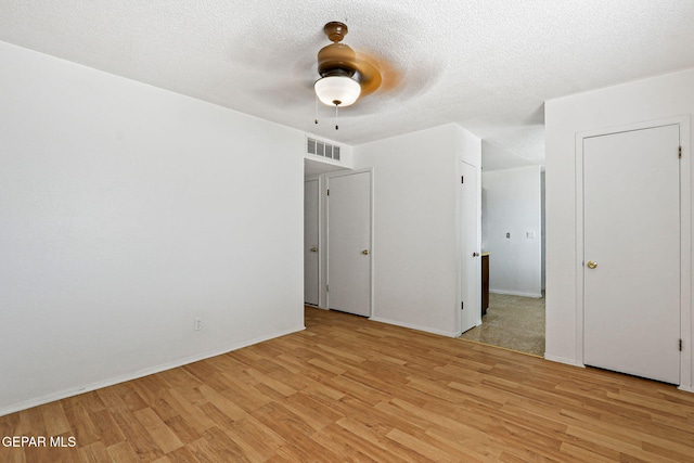 8957 Robert Dr Unit A & B, El Paso, TX 79904 - spare room featuring light wood-type flooring, ceiling fan, a textured ceiling, and baseboards