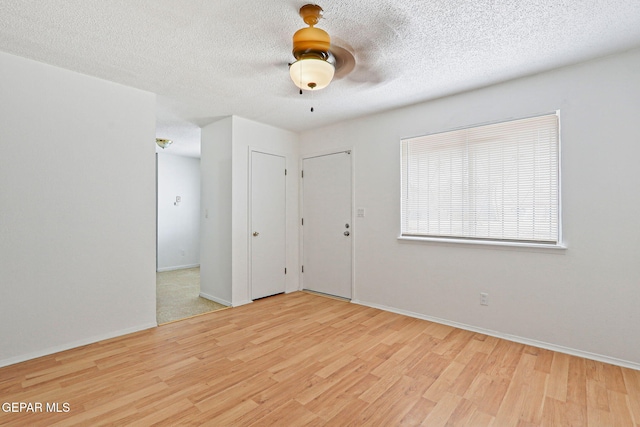 8957 Robert Dr Unit A & B, El Paso, TX 79904 - spare room with wood finished floors, ceiling fan, baseboards, and a textured ceiling