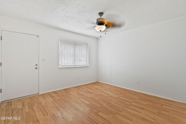 8957 Robert Dr Unit A & B, El Paso, TX 79904 - spare room featuring light wood-style flooring, ceiling fan, a textured ceiling, and baseboards