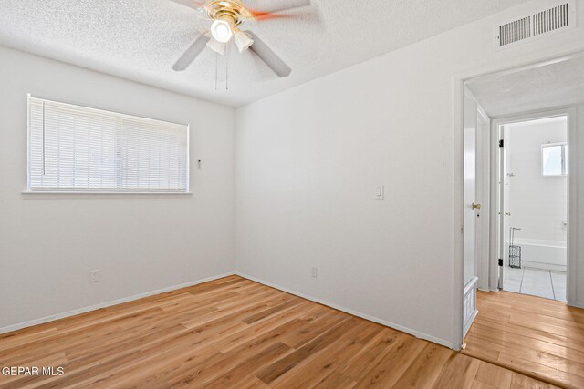 8957 Robert Dr Unit A & B, El Paso, TX 79904 - empty room featuring light wood-style floors, ceiling fan, a textured ceiling, and baseboards