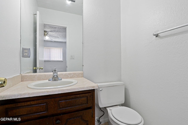 8957 Robert Dr Unit A & B, El Paso, TX 79904 - bathroom featuring vanity, toilet, a ceiling fan, and a textured ceiling