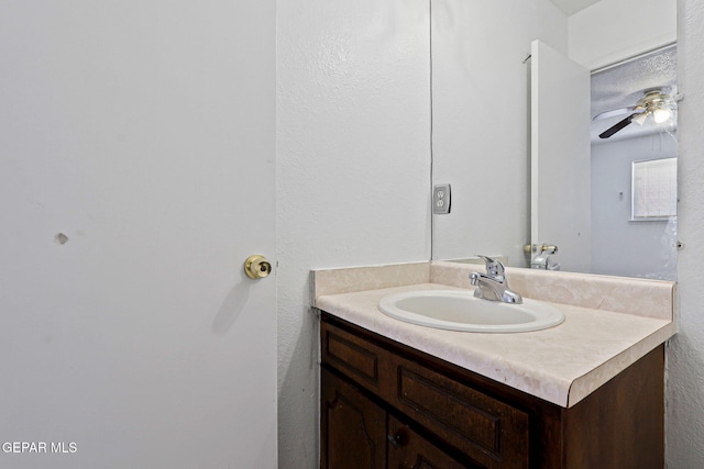 8957 Robert Dr Unit A & B, El Paso, TX 79904 - bathroom featuring vanity, ceiling fan, and a textured wall