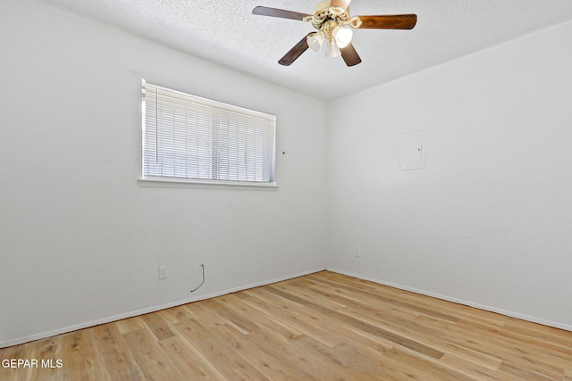 8957 Robert Dr Unit A & B, El Paso, TX 79904 - spare room featuring wood finished floors, a textured ceiling, a ceiling fan, and baseboards