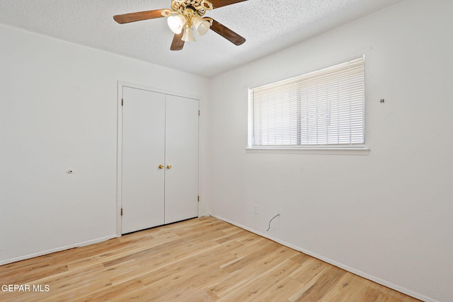 8957 Robert Dr Unit A & B, El Paso, TX 79904 - unfurnished bedroom featuring a textured ceiling, wood finished floors, baseboards, a closet, and a ceiling fan