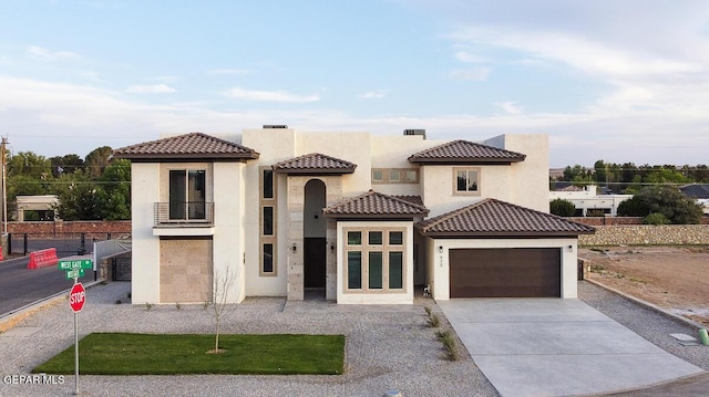 820 W Gate, El Paso, TX 79932 - mediterranean / spanish-style home with a balcony, stucco siding, concrete driveway, and a garage