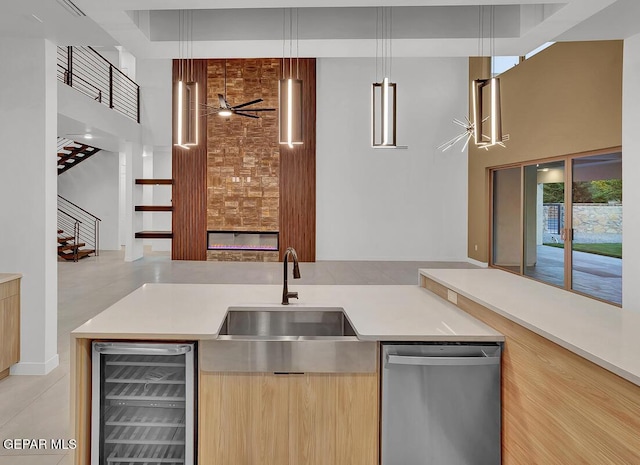 820 W Gate, El Paso, TX 79932 - kitchen featuring beverage cooler, dishwasher, a sink, a towering ceiling, and open floor plan