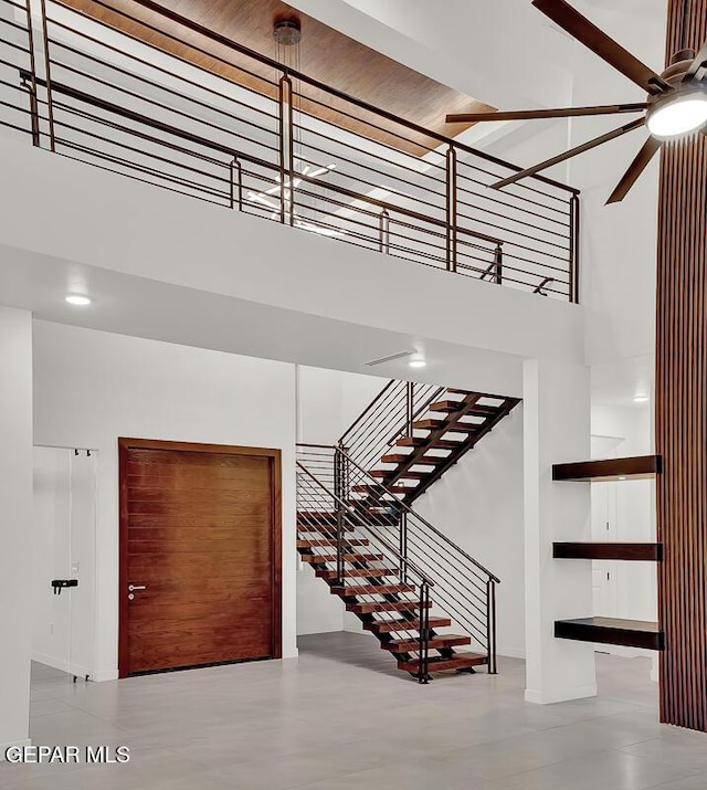 820 W Gate, El Paso, TX 79932 - stairs featuring a towering ceiling, ceiling fan, and baseboards