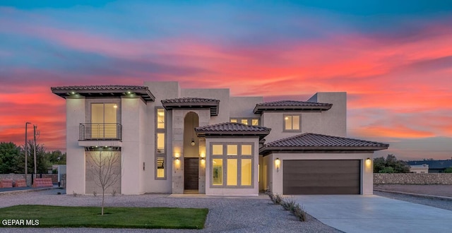 820 W Gate, El Paso, TX 79932 - mediterranean / spanish-style home featuring a balcony, a garage, driveway, stucco siding, and a tile roof