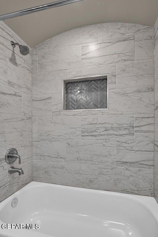 13404 Coldham St, El Paso, TX 79928 - bathroom with washtub / shower combination and lofted ceiling
