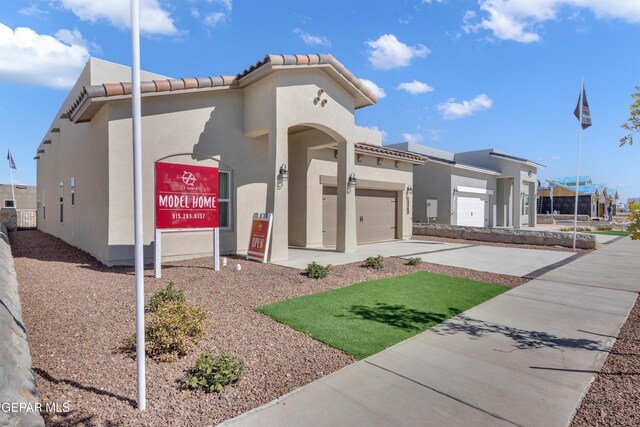 13404 Coldham St, El Paso, TX 79928 - view of front of property featuring stucco siding, driveway, an attached garage, and a tile roof