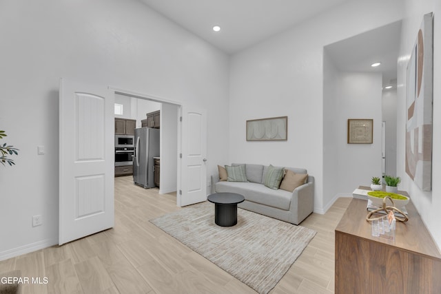 13404 Coldham St, El Paso, TX 79928 - living room with baseboards, recessed lighting, a high ceiling, and light wood-type flooring