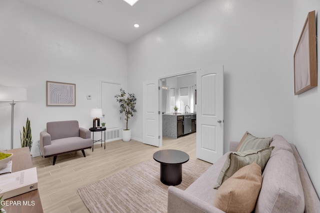 13404 Coldham St, El Paso, TX 79928 - living room featuring a high ceiling, light wood-type flooring, baseboards, and recessed lighting