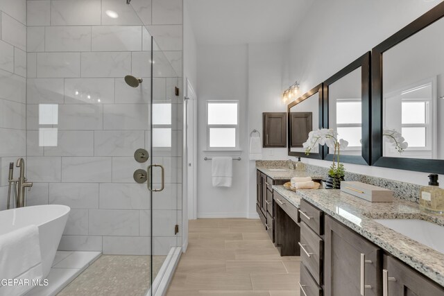 13404 Coldham St, El Paso, TX 79928 - bathroom with double vanity, a stall shower, healthy amount of natural light, and a freestanding tub