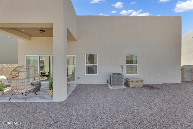 13404 Coldham St, El Paso, TX 79928 - rear view of house with stucco siding, central AC unit, and a patio