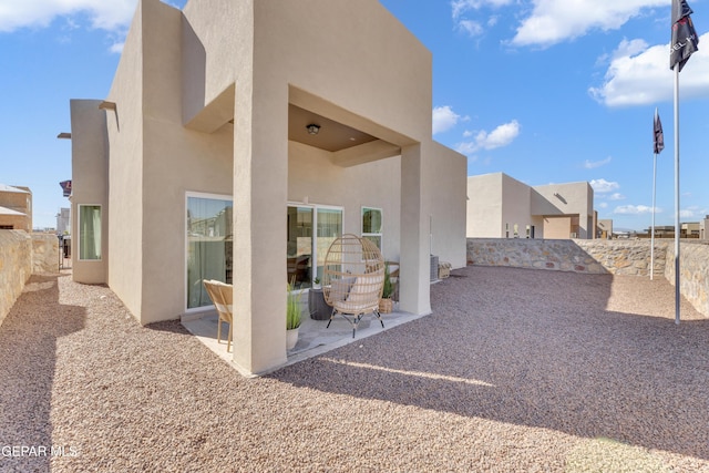 13404 Coldham St, El Paso, TX 79928 - back of property with stucco siding, a patio area, and a fenced backyard