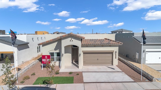 13404 Coldham St, El Paso, TX 79928 - mediterranean / spanish home with a garage, a tiled roof, stucco siding, and driveway
