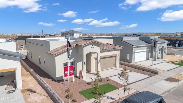 13404 Coldham St, El Paso, TX 79928 - view of front of house featuring concrete driveway, stucco siding, a tile roof, and a garage