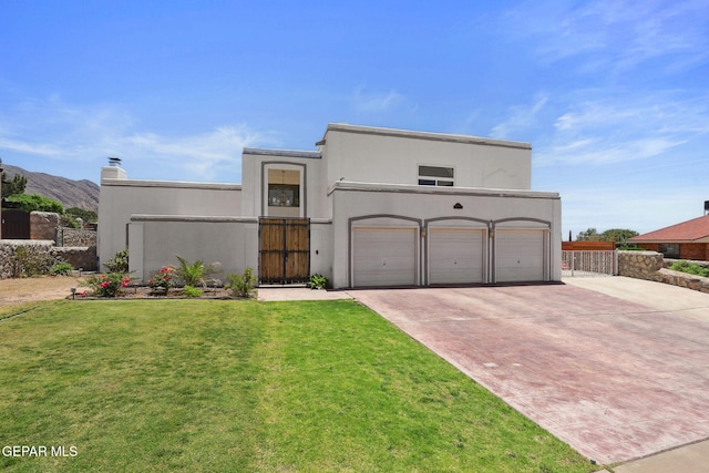 6008 Camino Alegre Dr, El Paso, TX 79912 - view of front of home with concrete driveway, a garage, stucco siding, and a mountain view
