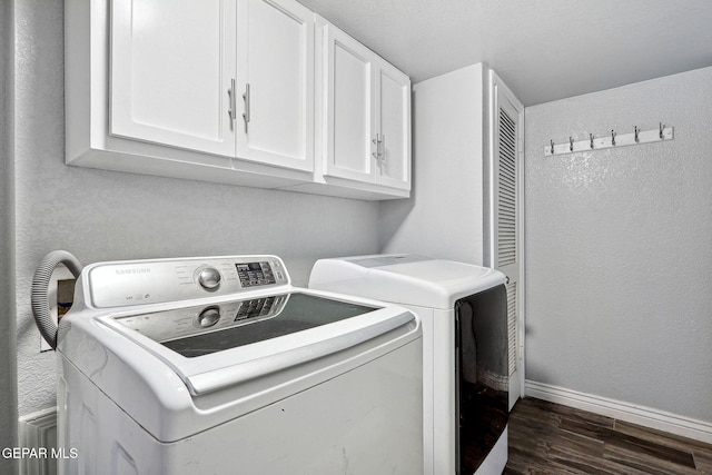 6008 Camino Alegre Dr, El Paso, TX 79912 - laundry room with cabinet space, washing machine and dryer, dark wood-type flooring, and baseboards