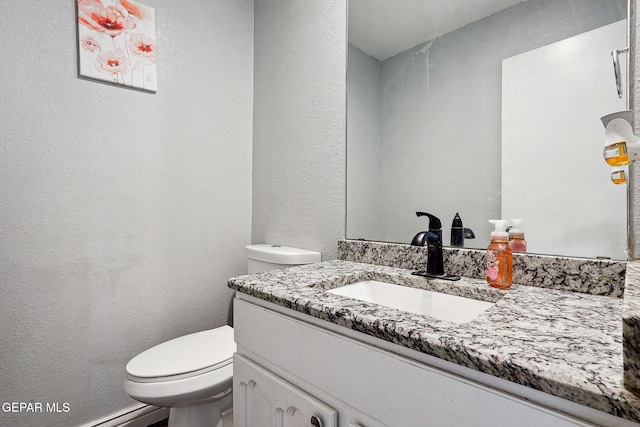 6008 Camino Alegre Dr, El Paso, TX 79912 - half bath with a textured wall, toilet, and vanity