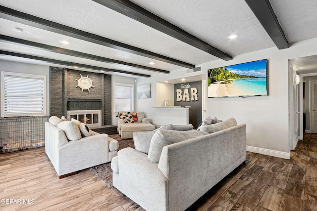 6008 Camino Alegre Dr, El Paso, TX 79912 - living area featuring baseboards, a fireplace, wood finished floors, beam ceiling, and recessed lighting