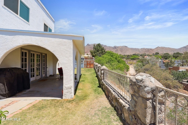6008 Camino Alegre Dr, El Paso, TX 79912 - view of yard featuring french doors, a mountain view, and a patio