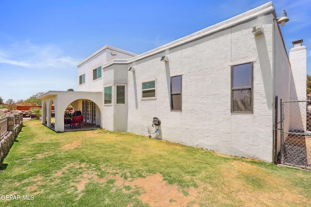 6008 Camino Alegre Dr, El Paso, TX 79912 - rear view of property featuring stucco siding and a patio