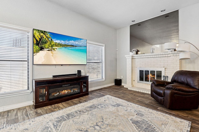 6008 Camino Alegre Dr, El Paso, TX 79912 - living room with a brick fireplace, baseboards, and wood finished floors