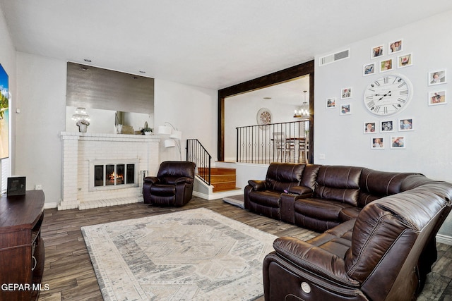 6008 Camino Alegre Dr, El Paso, TX 79912 - living area featuring wood finished floors, a chandelier, and a fireplace