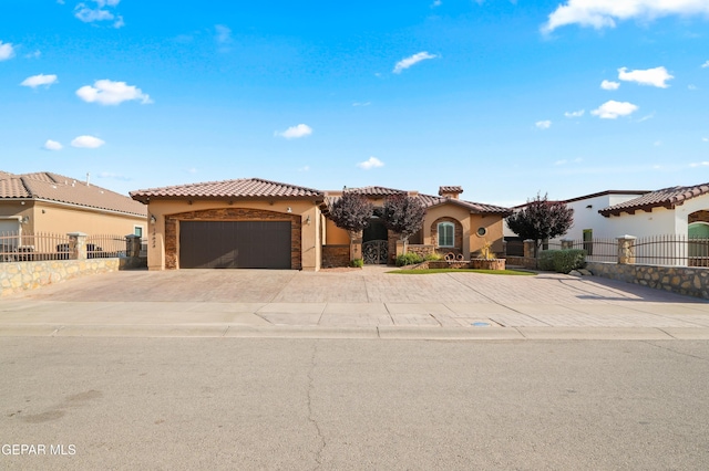14624 Long Shadow Ave, El Paso, TX 79938 - mediterranean / spanish house with stucco siding, driveway, an attached garage, a tile roof, and a gate