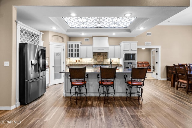 14624 Long Shadow Ave, El Paso, TX 79938 - kitchen featuring appliances with stainless steel finishes, crown molding, a raised ceiling, a kitchen breakfast bar, and recessed lighting