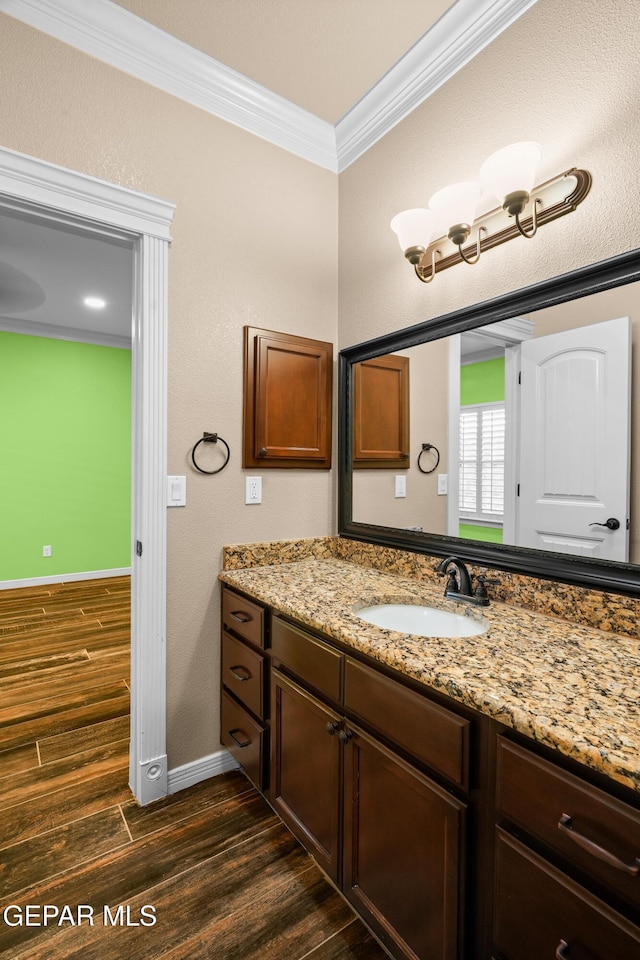 14624 Long Shadow Ave, El Paso, TX 79938 - bathroom with ornamental molding, wood finished floors, vanity, and baseboards