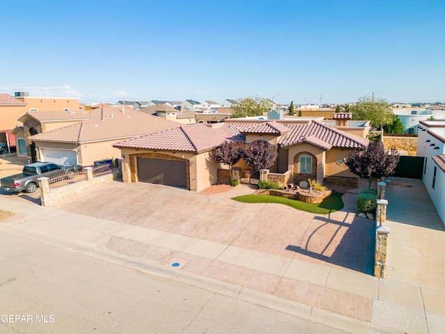 14624 Long Shadow Ave, El Paso, TX 79938 - mediterranean / spanish-style house with stucco siding, a tiled roof, a garage, driveway, and a residential view