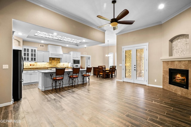 14624 Long Shadow Ave, El Paso, TX 79938 - kitchen featuring freestanding refrigerator, stainless steel microwave, wood finished floors, crown molding, and ceiling fan