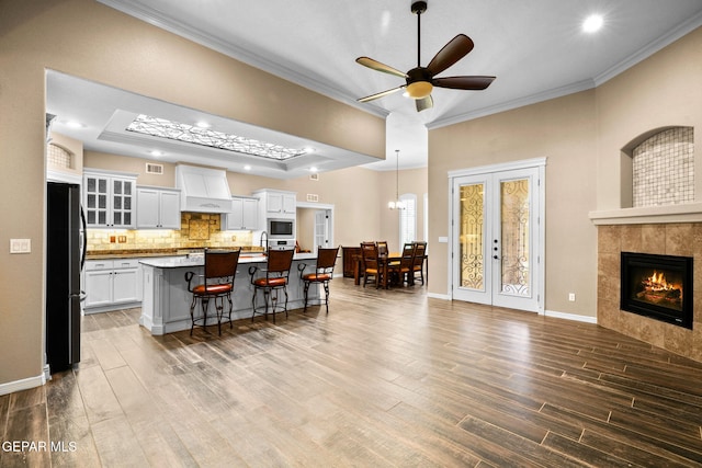 14624 Long Shadow Ave, El Paso, TX 79938 - kitchen featuring freestanding refrigerator, stainless steel microwave, ornamental molding, wood finished floors, and a ceiling fan